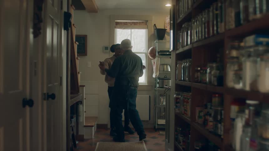 A woman begins dancing with a man by the door