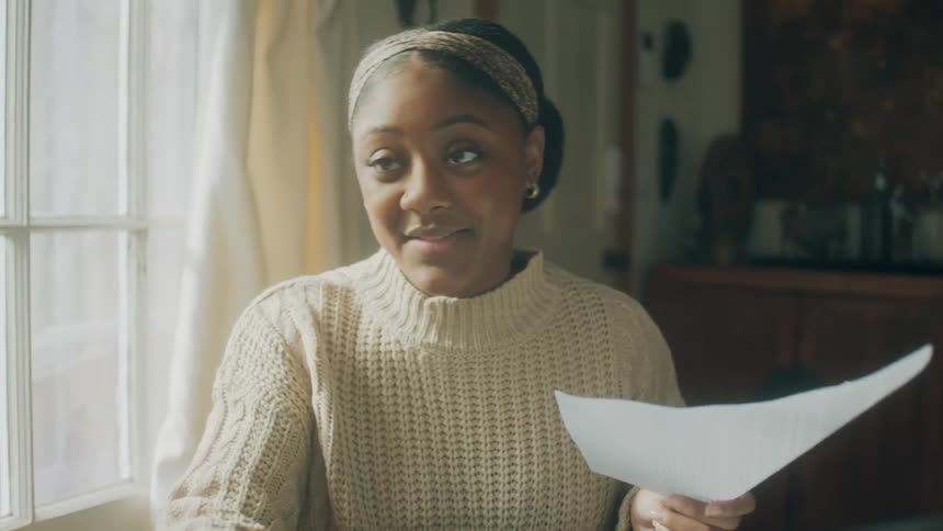 A woman talks with a man while looking at paperwork