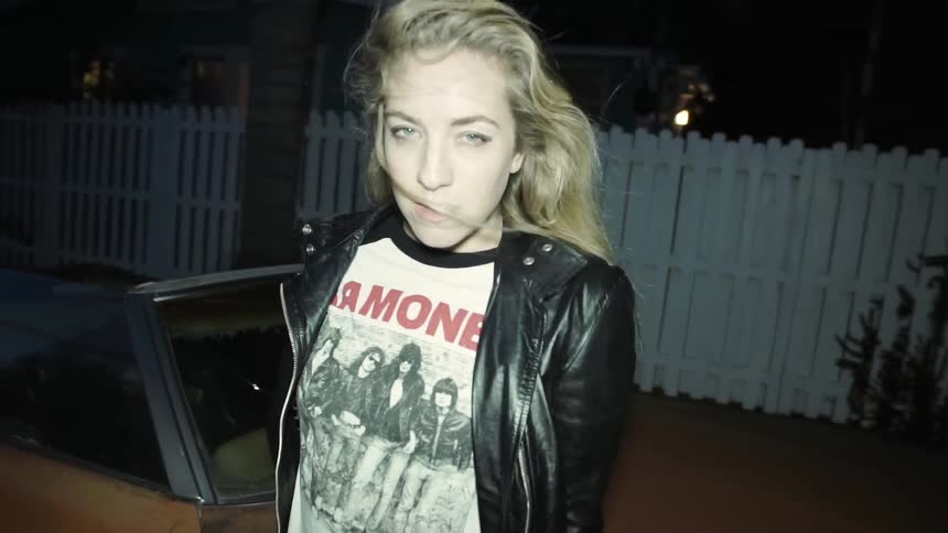 A blonde woman striking seductive poses for the camera
