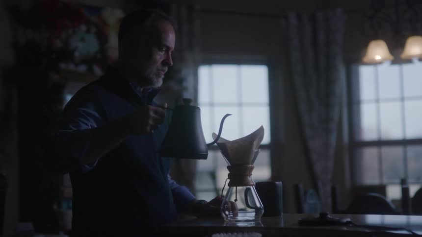 A man is brewing coffee at home