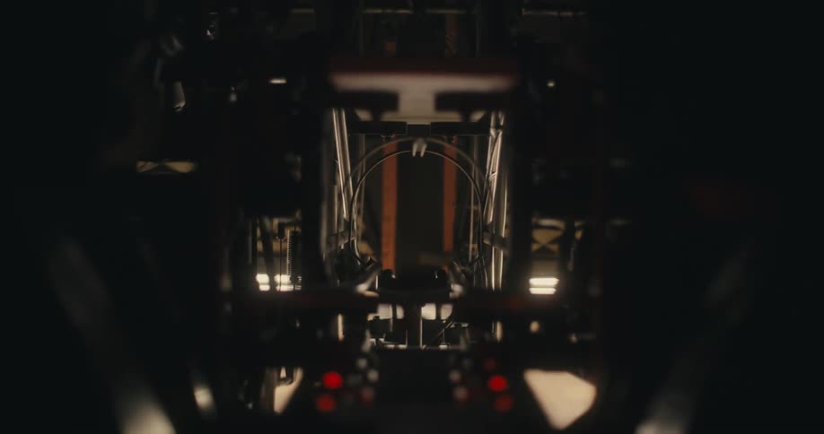 The machine is pushing out the bowling ball