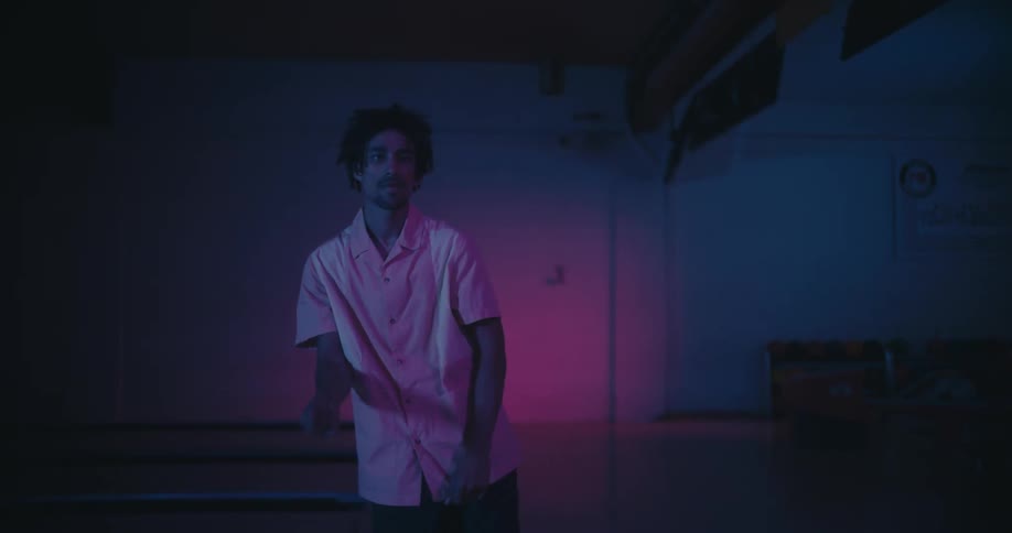 A man throws the bowling ball and starts dancing