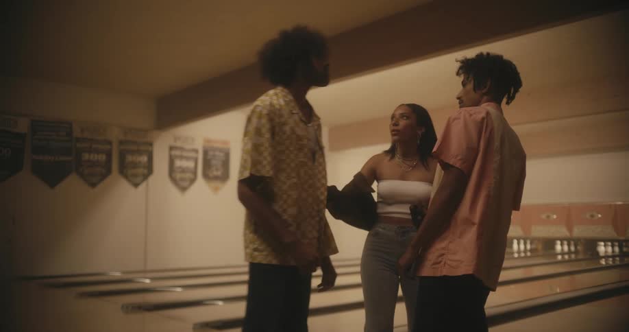 A man trying to start a fight with another man at a bowling alley