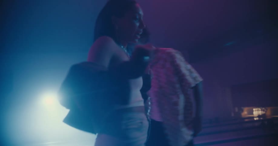 Young black man and woman dancing together and having fun in an empty bowling alley