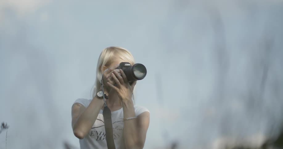 Woman uses her camera to capture the scene before her