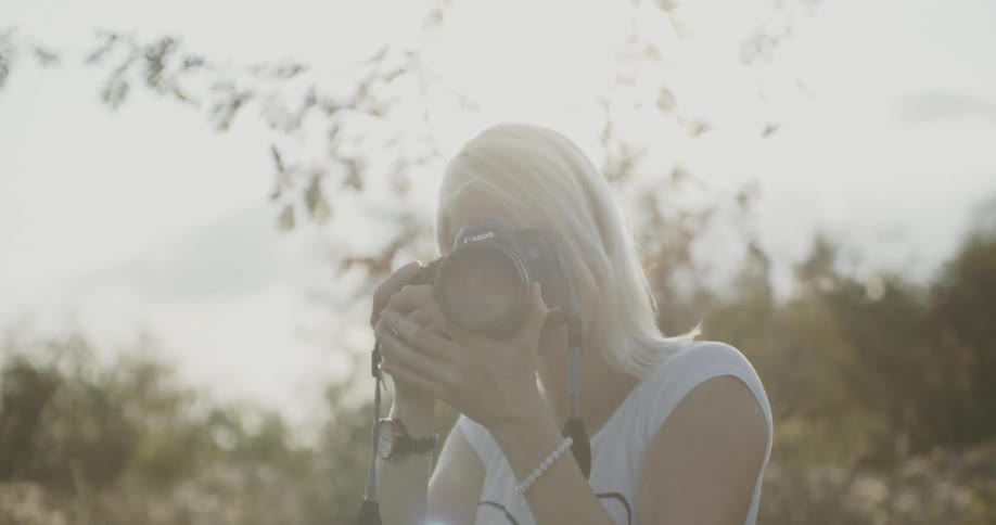 A female photographer follows the movement with her camera