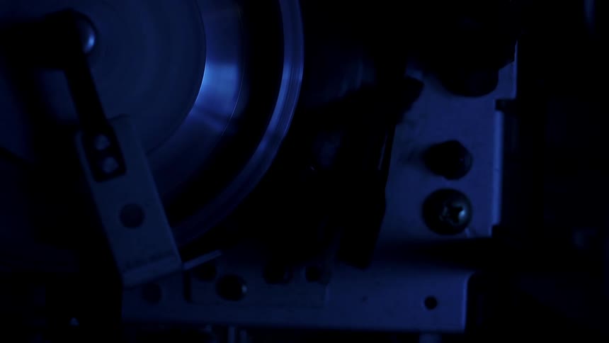 A machine spins in a dark room
