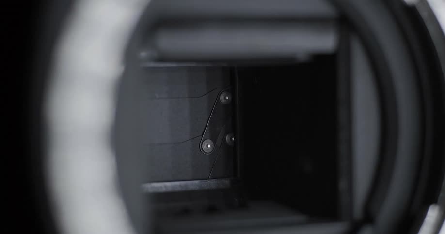 A camera shutter clicks up and down