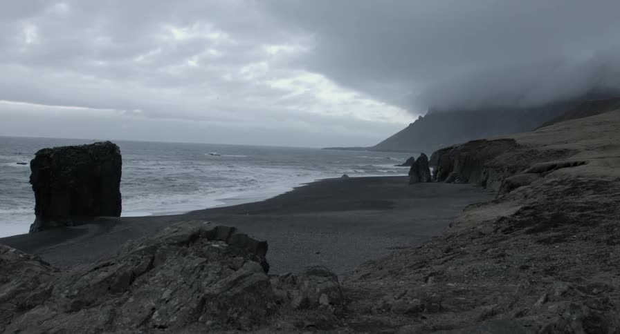 Waves roll onto a beach on a cloudy day
