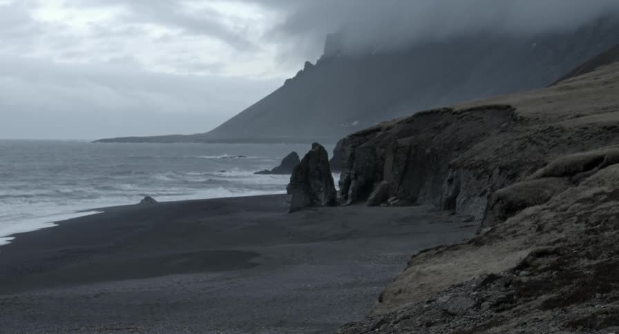 Waves roll onto a beach on a cloudy day
