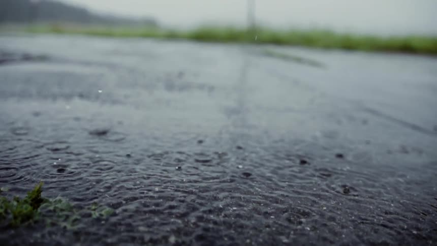 Rain falls down on a street