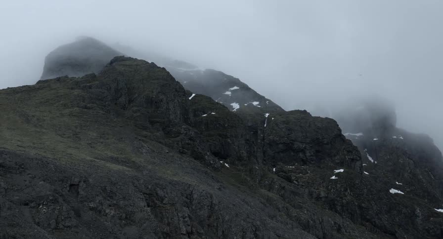 Heavy fog rolls into a mountainous area