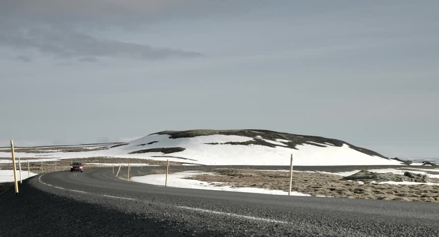 A car drives down a twisting road