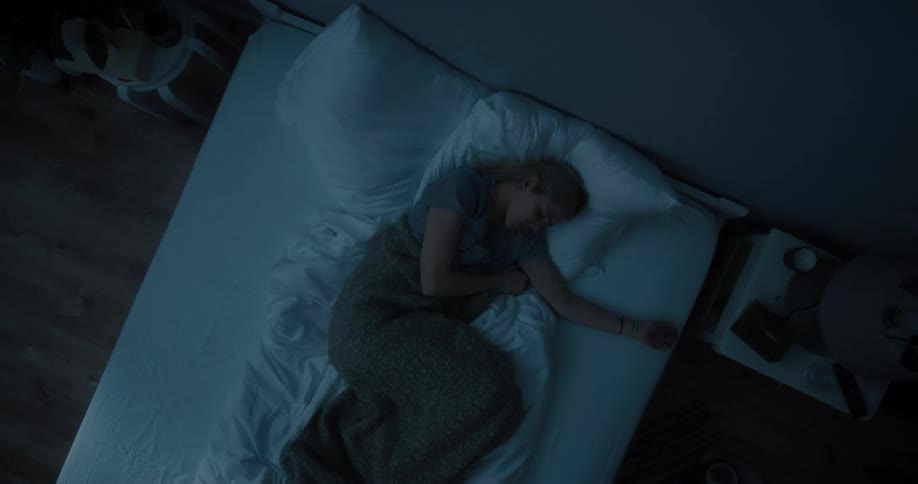 A woman is sleeping in a bed at night