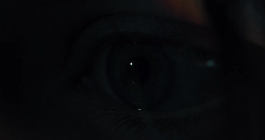 A close up of a light shining into a persons eyes