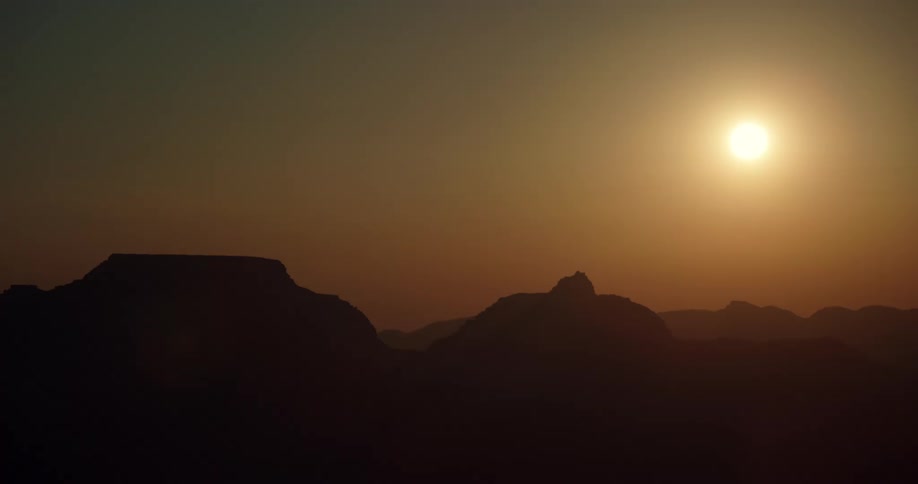 The sun sets over a canyon