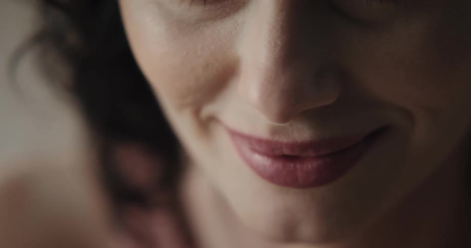 Close up of a woman applying lipstick with a lip liner