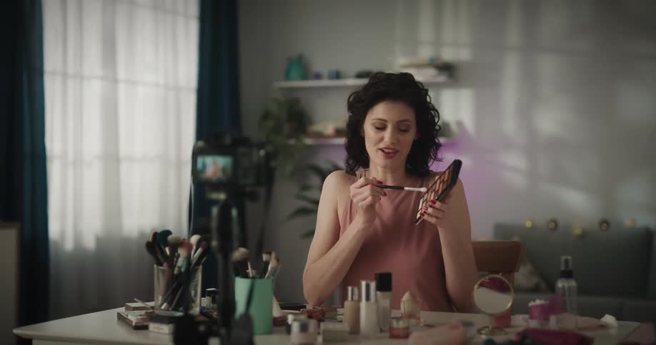 Woman filming a make up tutorial for social media