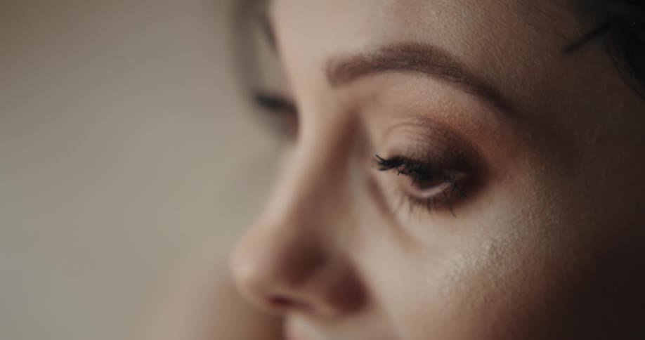 A woman putting on makeup