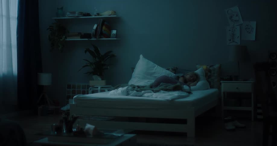 A woman fidgets a bit in her sleep
