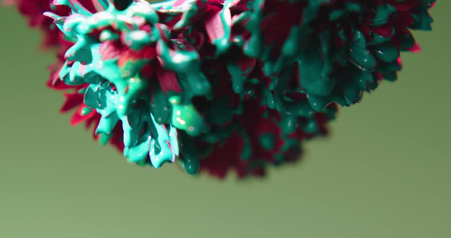 Green paint is dripping from a red carnation flower