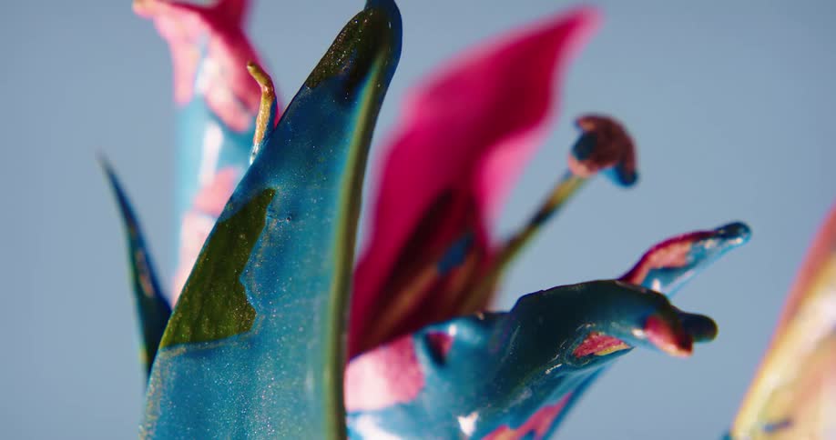 A flower covered in blue paint