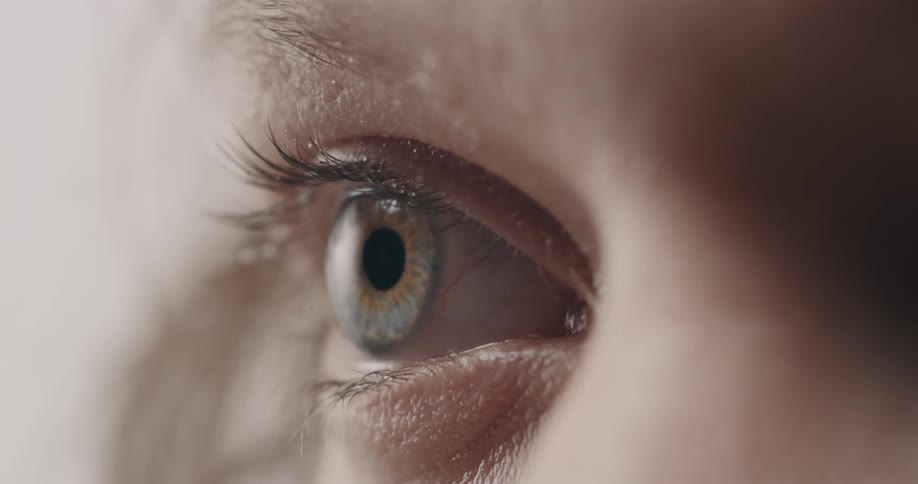 White persons blue eye opening and staring ahead