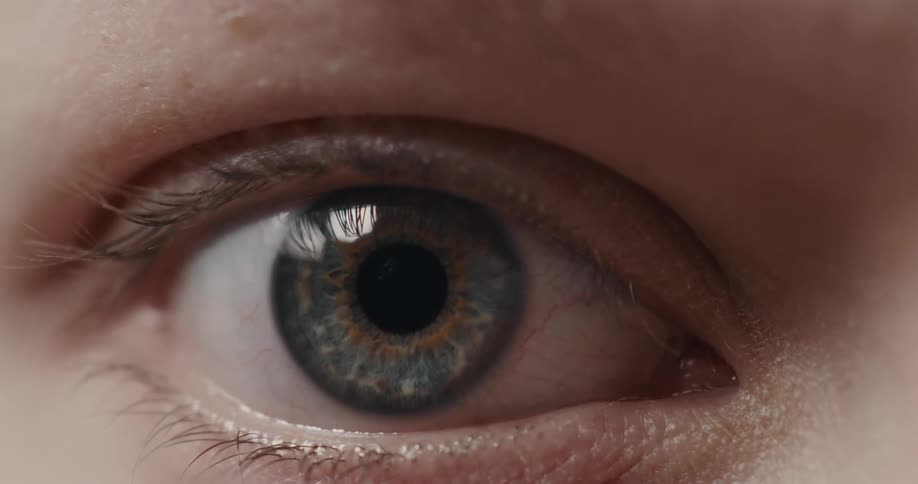 Eyelid closes over the blue eye