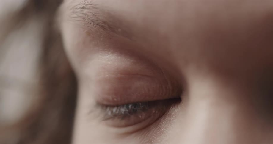 Eyelid blinks over the blue eye