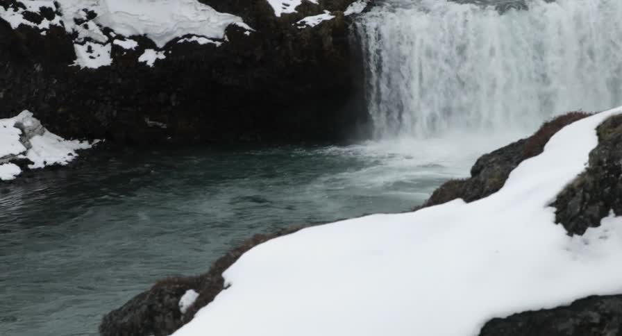 A river cuts through a snowy area