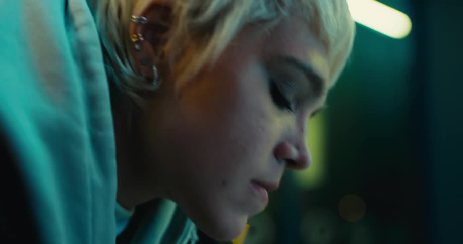 A young woman waits nervously inside a business