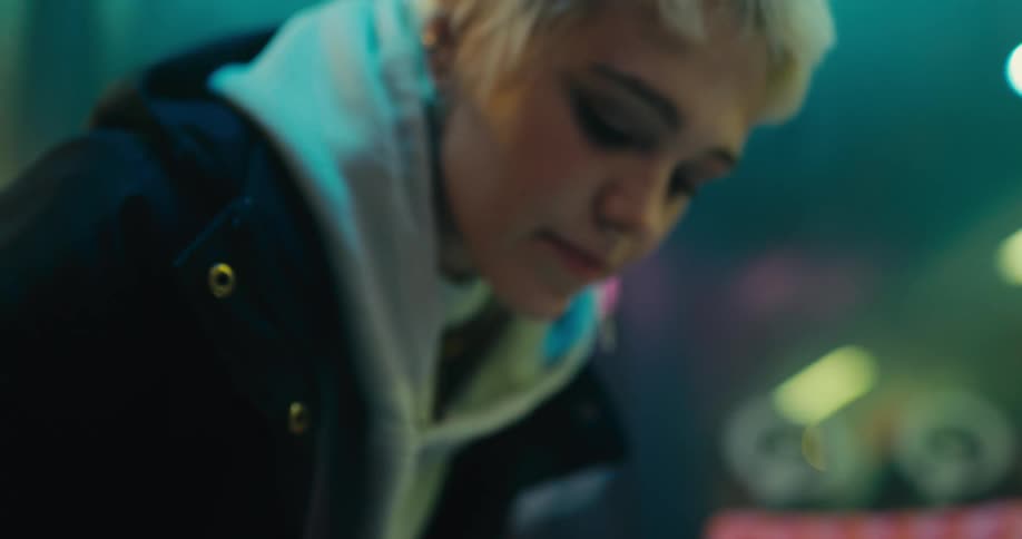 A woman is writing in her notebook at night