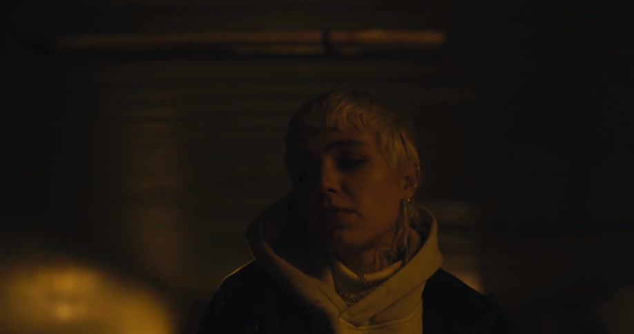 Blond teenaged girl looks nervous as she walks in a tunnel