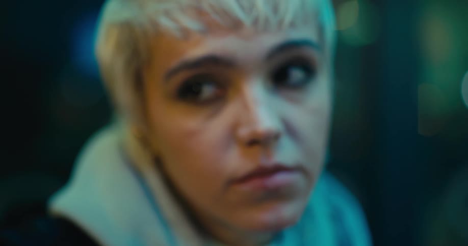 Blonde woman fidgets while she sits waiting