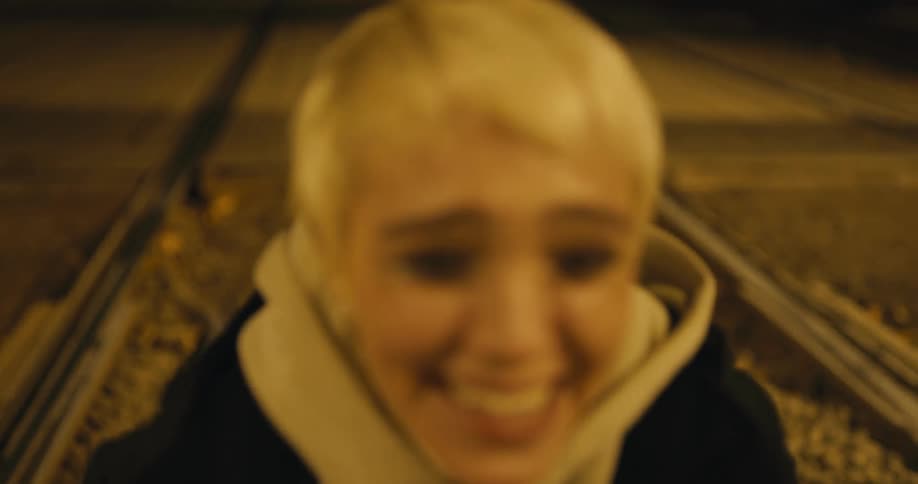 A woman laughs and cries at night