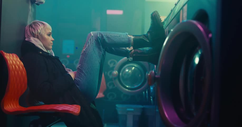 A woman puts her feet up on the washing machine