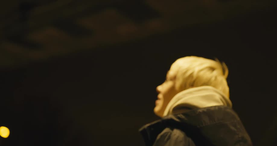A woman looks around nervously as the bus passes