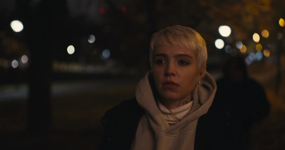A woman looks behind her and runs as she realizes a man is following her