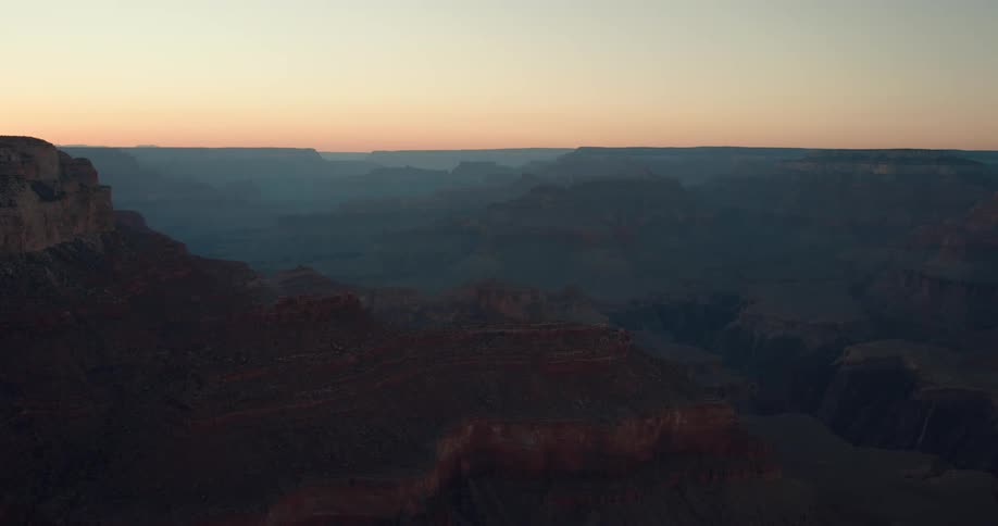 A mountain canyon and there are mountains and rock formations in the distance