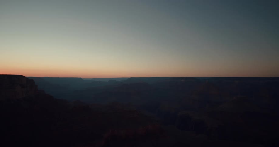 Silhouettes of rock formations and mountains as the sun has set