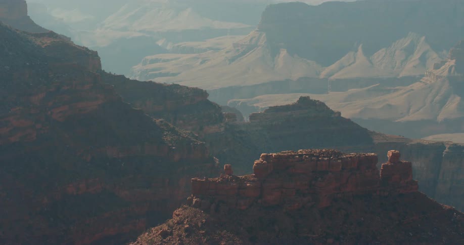 Rock formations and a mountain ridge with mountains in the distance