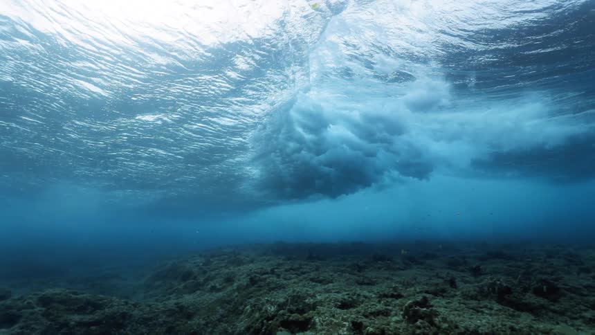 Surfing waves breaking underwater footage