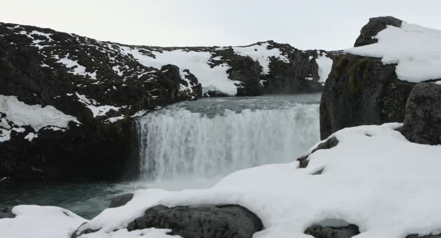 A waterfall in a snowy area