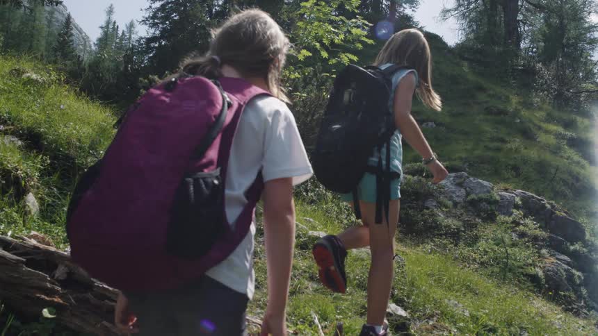 Two women hike up the hill
