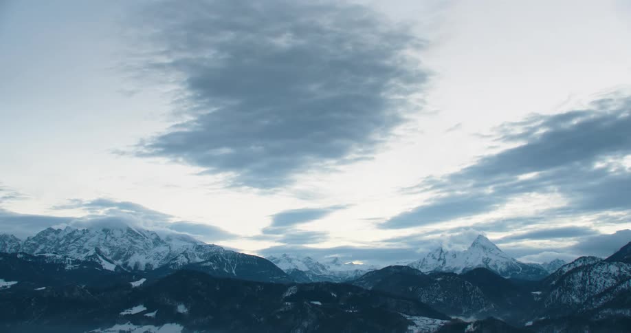Snow covered mountains under a cloudy sky