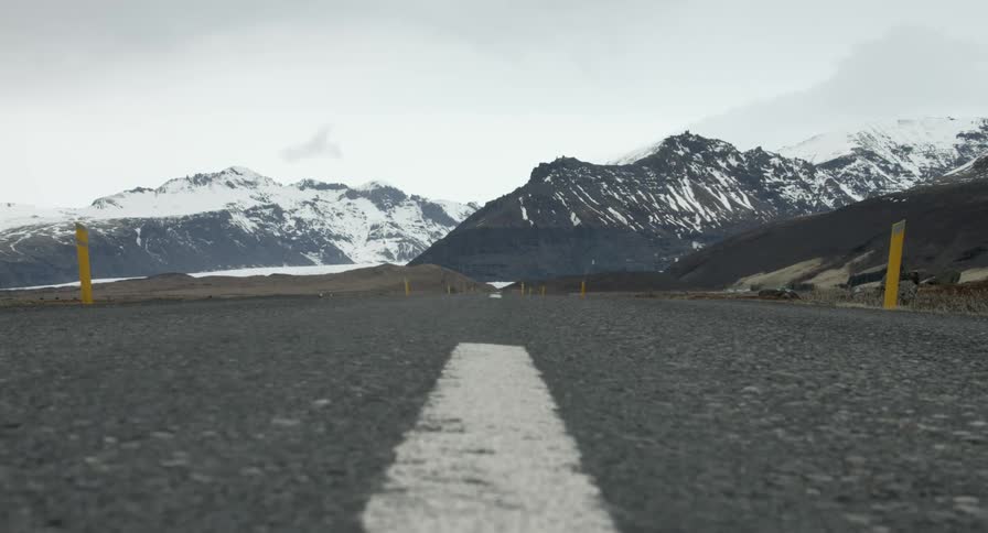 An empty road leading to mountains