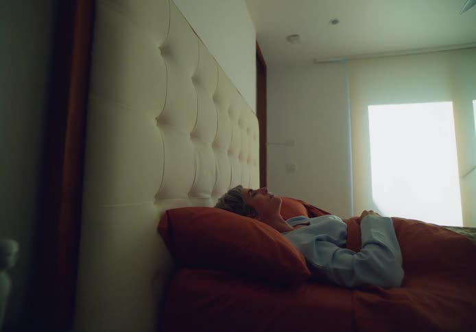 A woman waking up while lying in bed