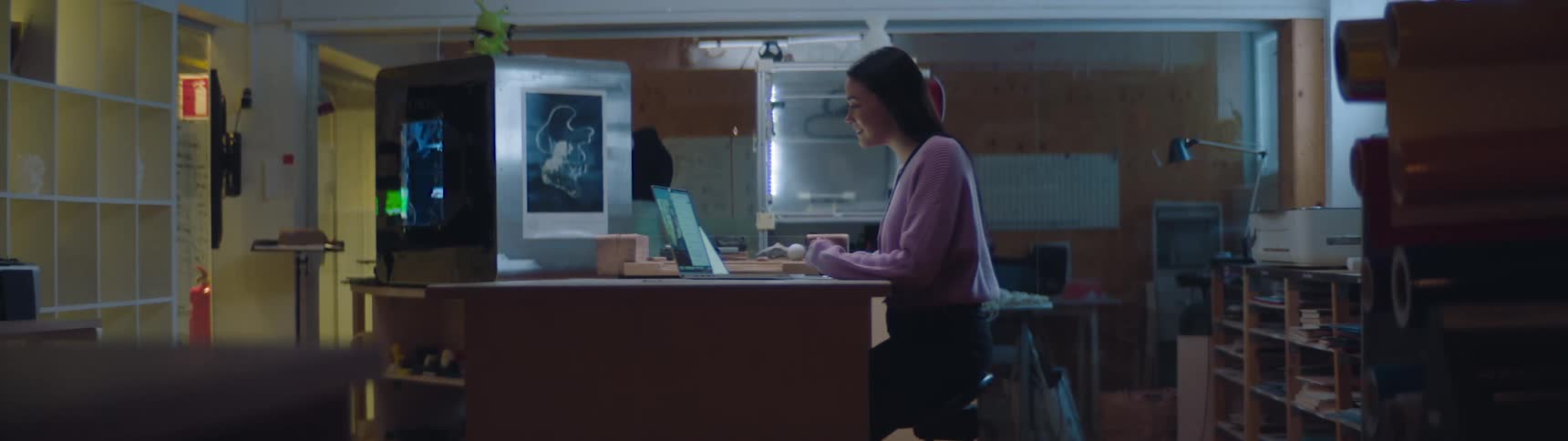 A woman video conferencing on a laptop in the workplace