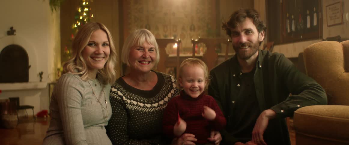 A family pose together at home
