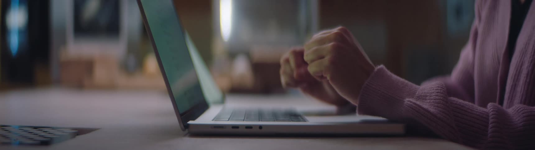Closeup view of a woman typing on a laptop